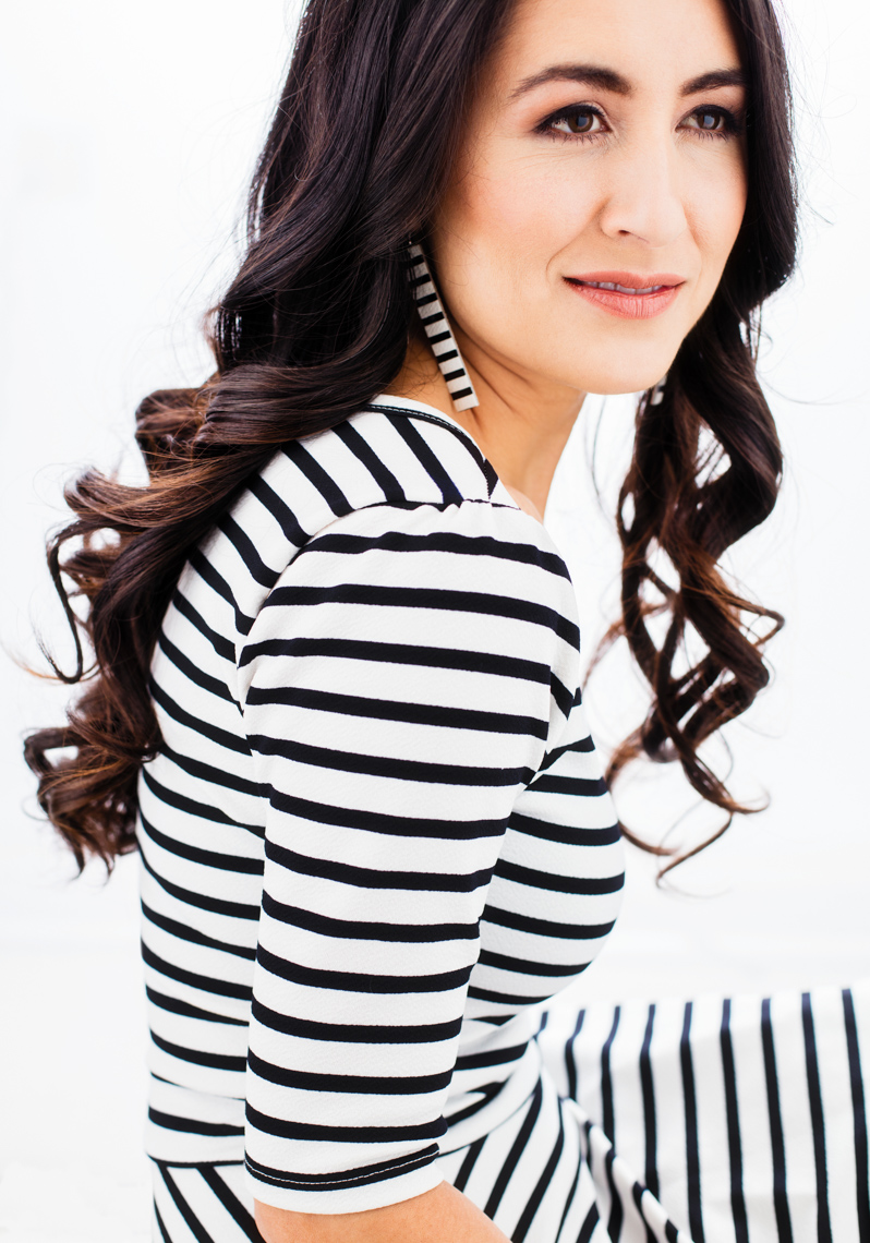 A beauty portrait of an attractive, beautiful, joyful, sexy, fun, classy, middle aged women, showcasing her natural beauty, femininity, personality, and style! She is a sexy white and black striped form fitting dress. Her beauty jumps out from this picture. This portrait was created by Steve Glass, owner of the Portrait Studio of Glass Photography. They offer a beauty portrait service (a makeover portrait) session, where professional hair, professional makeup, professional styling, are provided in the sitting fee. In all of their portraits they are looking to uncover the unique interests, creativity and beauty that each person possesses. This deepest portion of a person that is created in the image of God, the Imago Dei. Steve Glass, a professional portrait photographer of Glass Photography services the men, women, children, kids, families, business and people of Fort Collins, Windsor, Loveland, Wellington and the surrounding areas of Northern Colorado and southern Wyoming (and sometime Denver), through professional photography by creating timeless portraits and heirloom prints, ranging from corporate portraits, corporate headshots, environmental portraits, editorial portraits, and beauty portraits. 