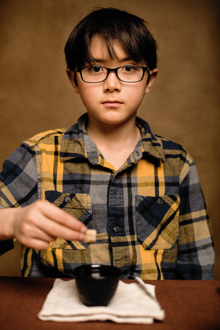A studio portrait of a strong, handsome 9-year-old boy who loves cups of tea, tall tales, stories and a good conversation. He wants to be a comic or a writer someday – or both. This portrait was created by Steve Glass, owner of Glass Photography Portrait Studio. In all, of his portraits he is seeking the Imago Dei – the image of God – in each of his subjects. This means uncovering the unique interests, creativity, ingenuity and beauty that each person possesses. This deepest portion of a person that is created in the image of God, the Imago Dei. Steve Glass, a professional portrait photographer of Glass Photography services the men, women, children, kids, families, business and people of Fort Collins, Windsor, Loveland, Wellington and the surrounding areas of Northern Colorado and southern Wyoming (and sometime Denver), through professional photography by creating timeless portraits and heirloom prints, ranging from corporate portraits, corporate headshots, environmental portraits, editorial portraits, and beauty portraits.